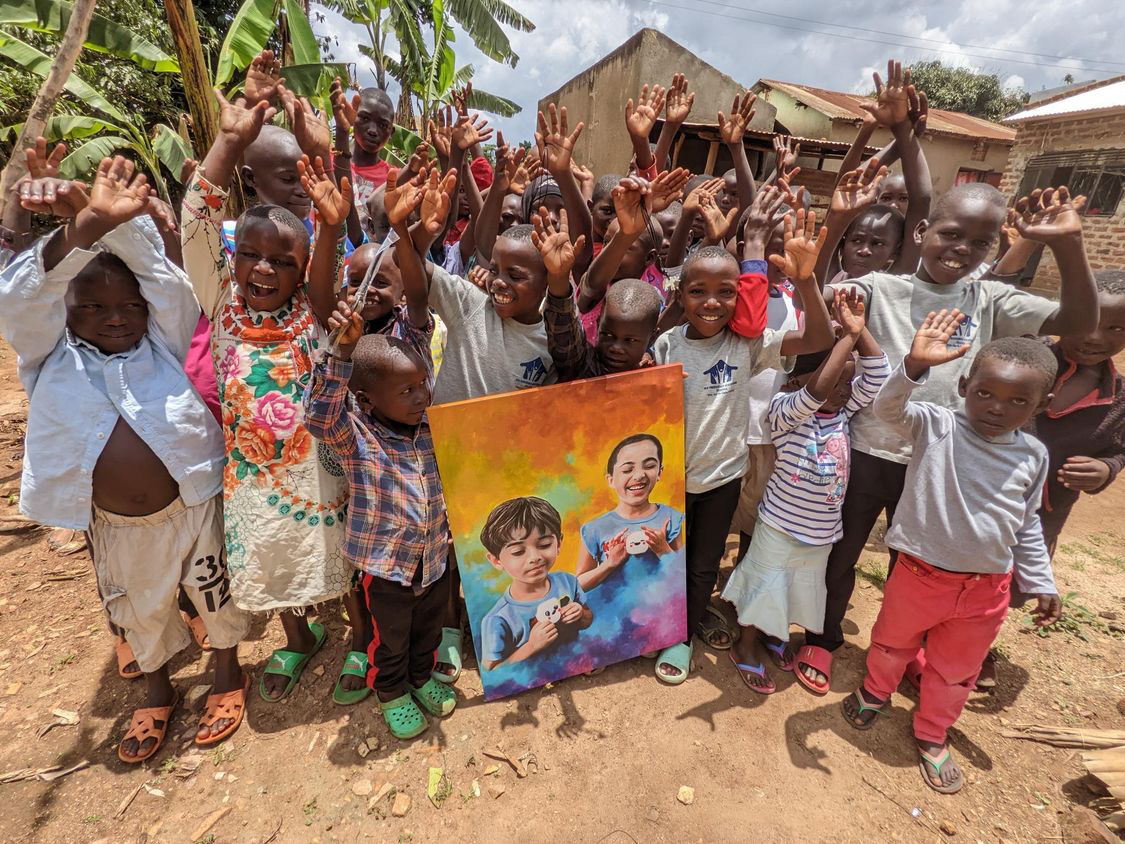 Children at the orphanage gathered together with the painting